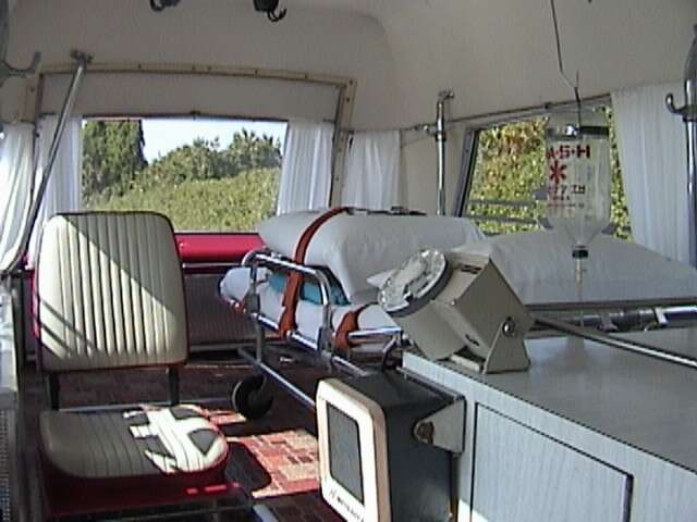 Retractible hooks/belts would be pulled down from the ceiling to hand two additional cots;  Notice metal hooks by side windows.  If more than one patient was in the car, the attendant (usually someone with first aid training) could not get to the patients.  Ambulances that had oxygen and two-way radios were considered the best.